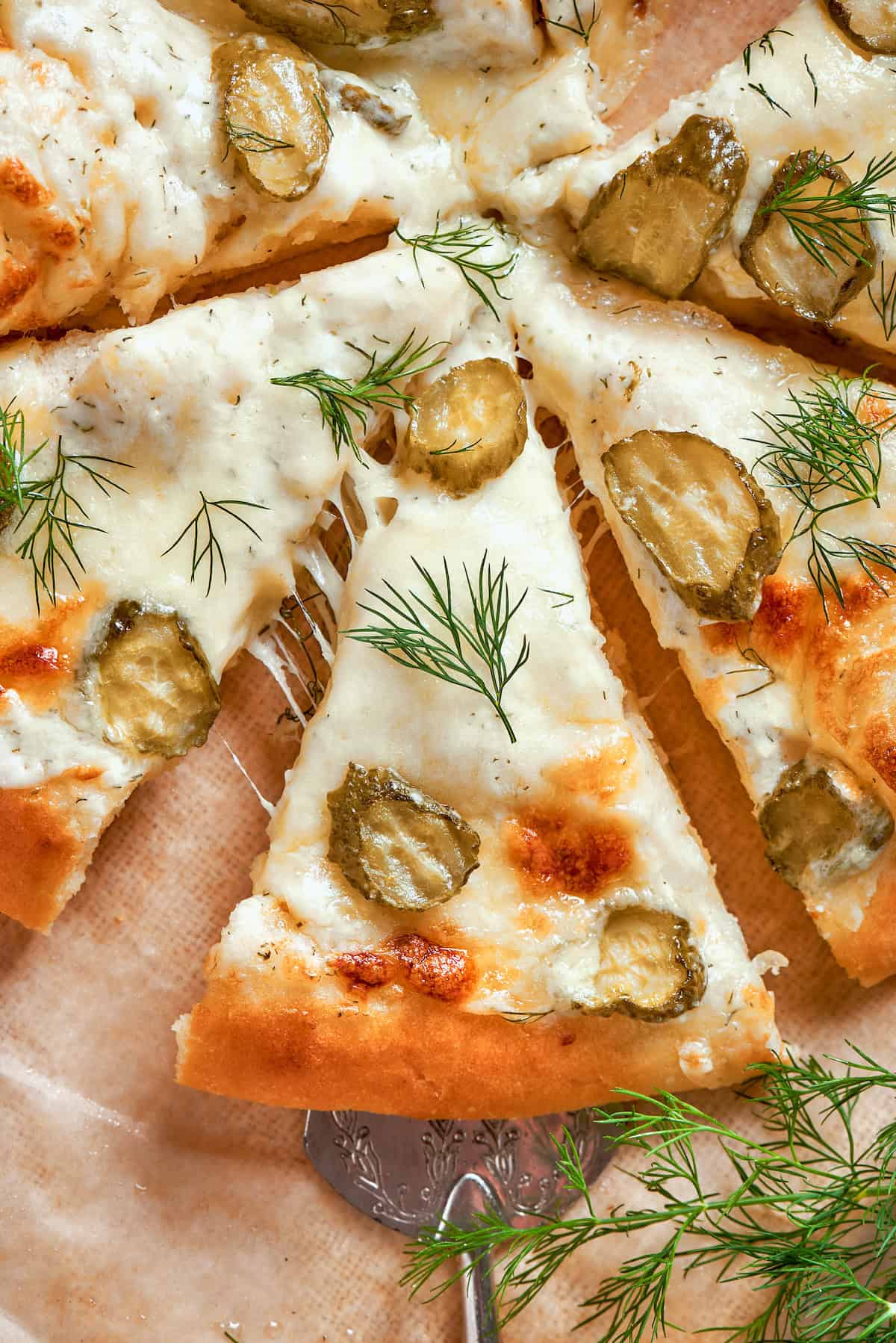 overhead photo pickle pizza cut into individual pieces