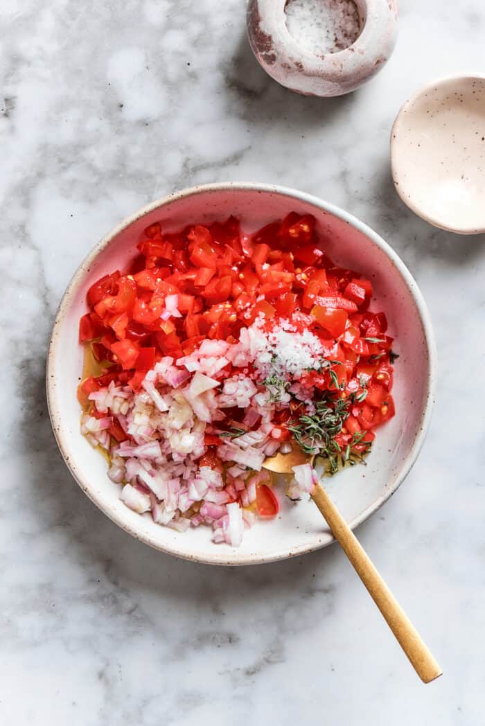 The tomato sauce ingredients are mixed in a bowl.