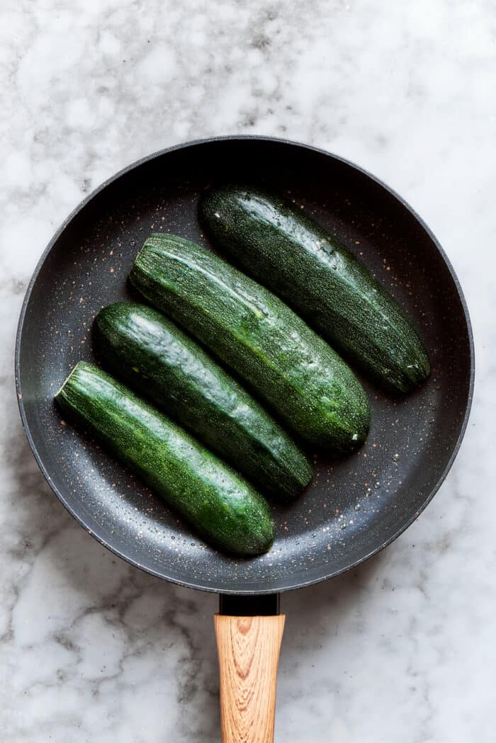 The zucchini is cooked in a pan.