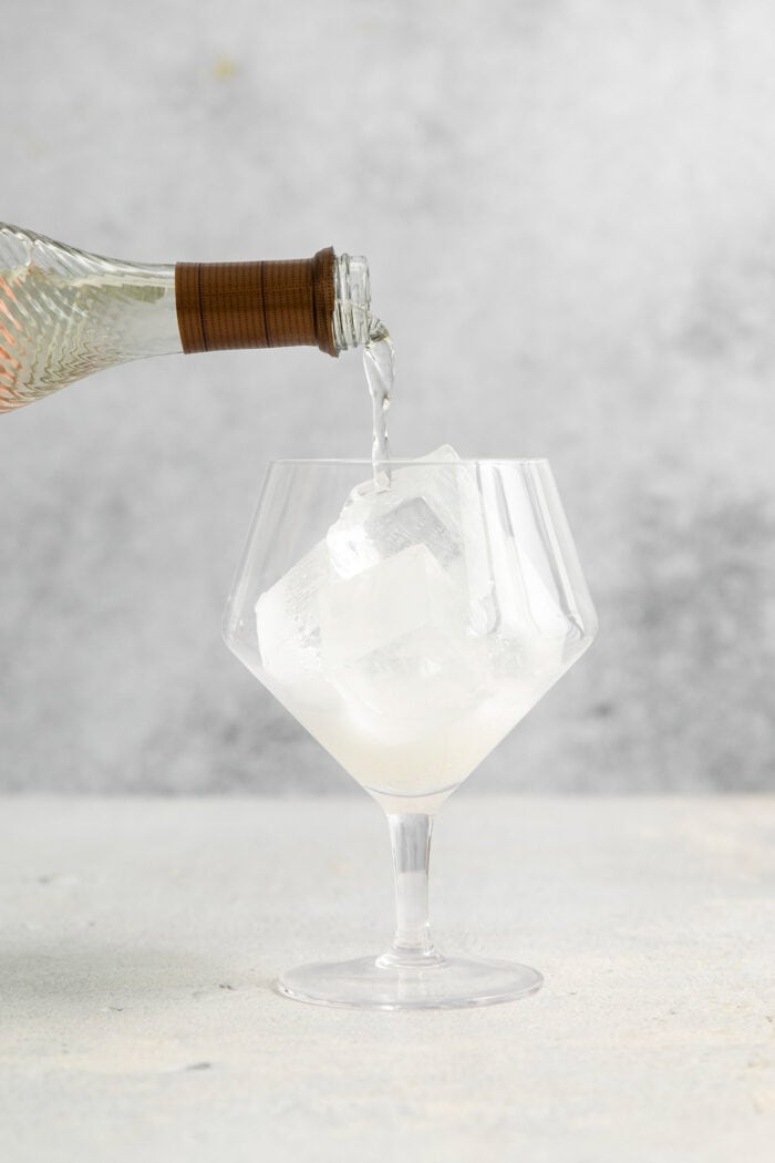 This refreshing, ruby-red Campari Spritz is a beautifully simple drink made with just 3 ingredients including campari and Prosecco. Prosecco is added to a glass with ice.