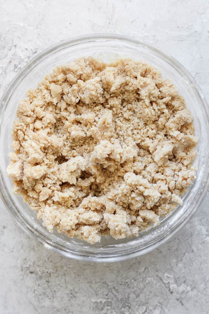 a clear bowl with the crumble topping ingredients combined