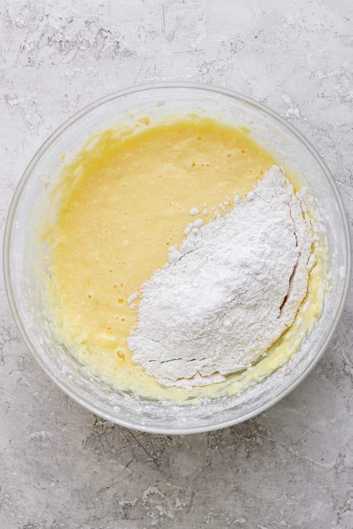 making the batter for the bars, adding flour to the combined wet ingredients
