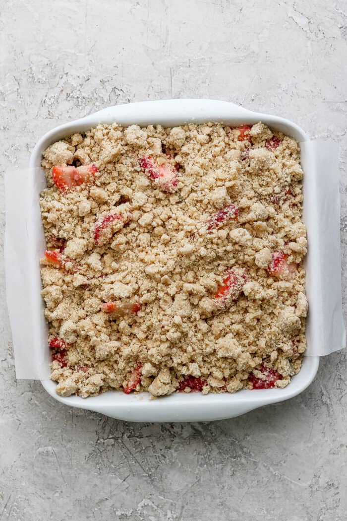 crumble topping sprinkled over the strawberry rhubarb mixture, ready to go into the oven