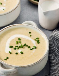 Bowls of vichyssoise are topped with chives.
