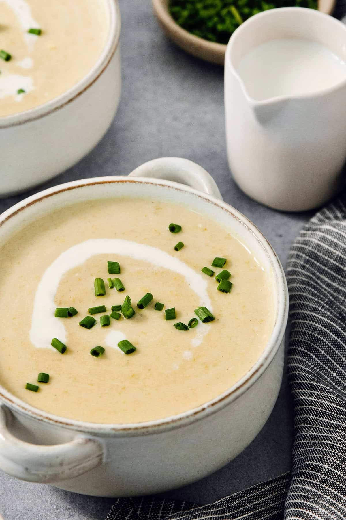 Bowls of vichyssoise are topped with chives.