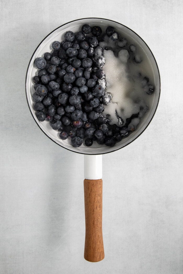 This Blueberry Butter is lightly sweet and luxuriously fluffy, with an easy homemade fresh blueberry sauce as its base. Blueberries are combined with other ingredients in a pot for blueberry sauce.