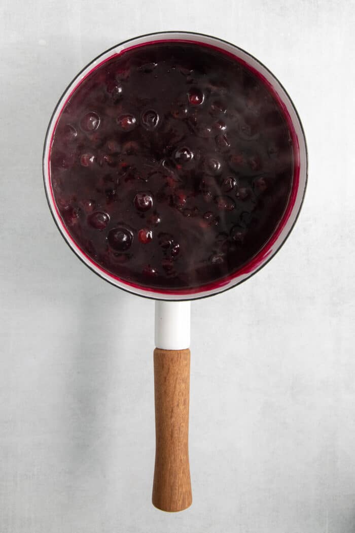 This Blueberry Butter is lightly sweet and luxuriously fluffy, with an easy homemade fresh blueberry sauce as its base. The blueberry sauce in a pot.