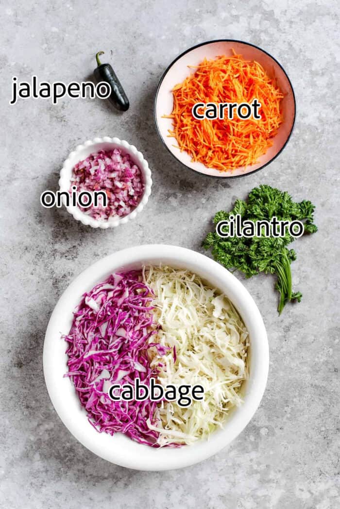 This jalapeño slaw recipe features a crunchy mix of vegetables including cabbage, cilantro, and carrots tossed in a lightly sweet dressing. vegetables needed to make jalapeno coleslaw