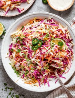 coleslaw with jalapeno and lime in a white bowl