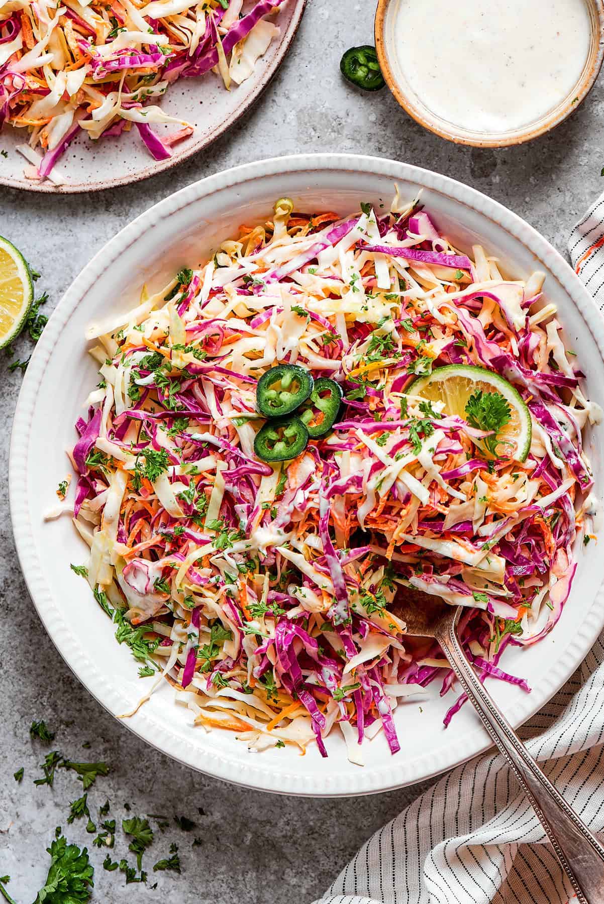 coleslaw with jalapeno and lime in a white bowl