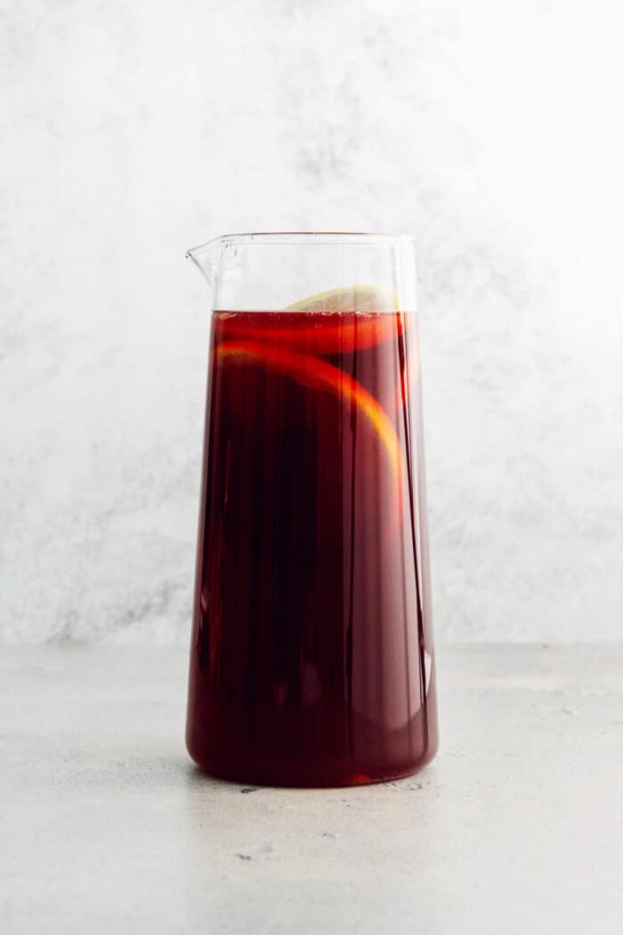 Tinto de Verano, a Spanish summertime cocktail, features fruity red wine, lemon soda, and red vermouth served over ice. A glass pitcher of tinto de verano.