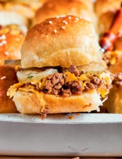 Ground beef is seen inside a cheeseburger slider.