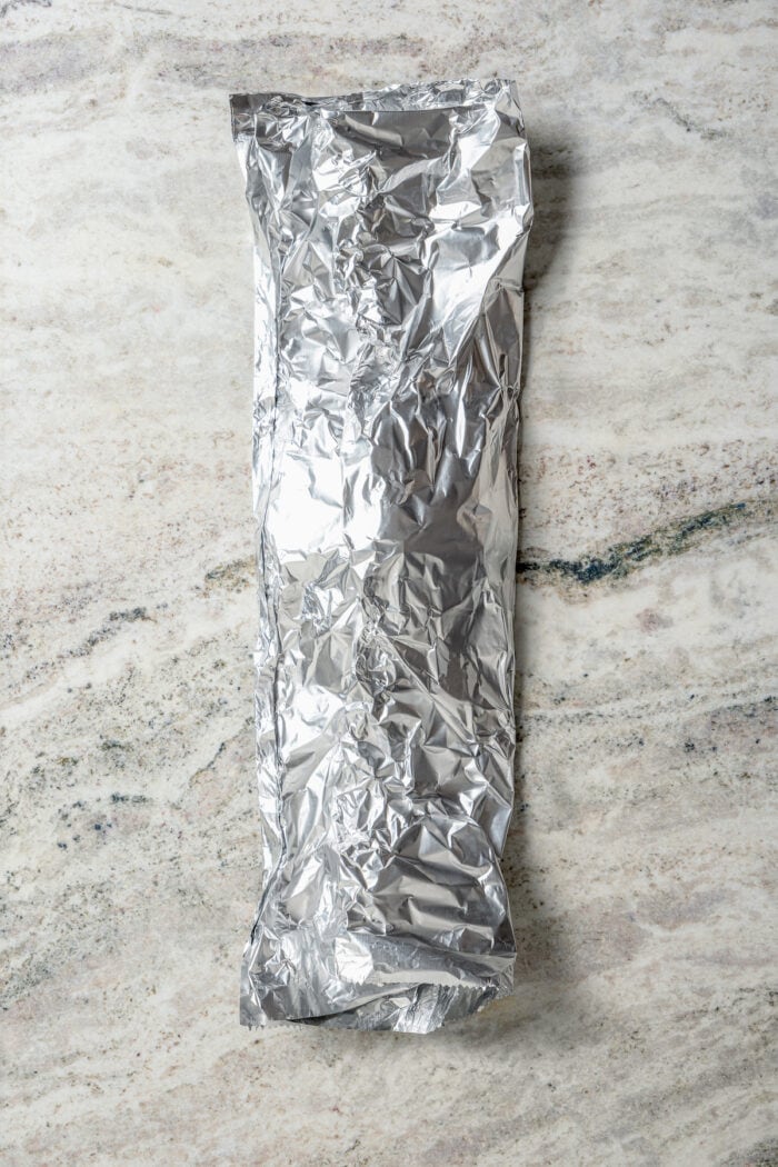 Savory Grilled Potato Packets feature grilled potatoes in foil dressed in tangy, garlicky pesto-ranch sauce and ready in less than 30 minutes. Potatoes are wrapped up a foil packet.