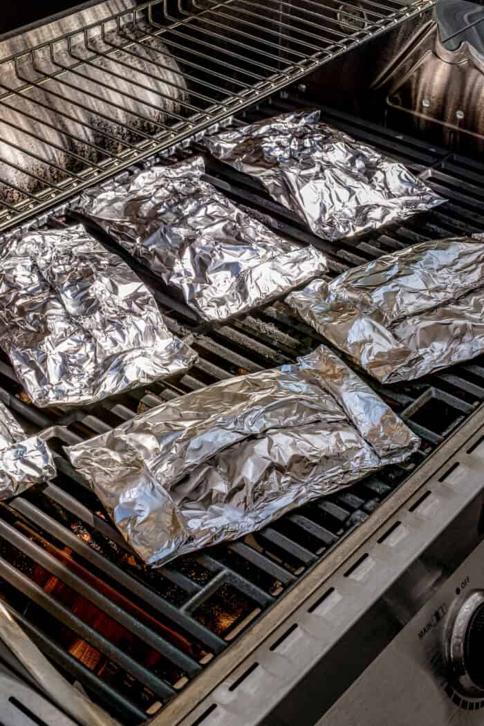 Savory Grilled Potato Packets feature grilled potatoes in foil dressed in tangy, garlicky pesto-ranch sauce and ready in less than 30 minutes. Grilled potato packets wrapped in foil on the grill.