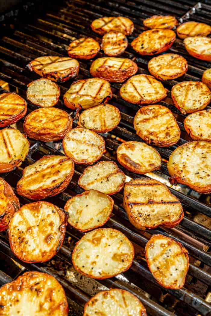 Crisp-tender Grilled Red Potatoes are spiked with the brisk flavors of dill, feta cheese, and lemon and grilled to perfection. The red potatoes are added to the grill.