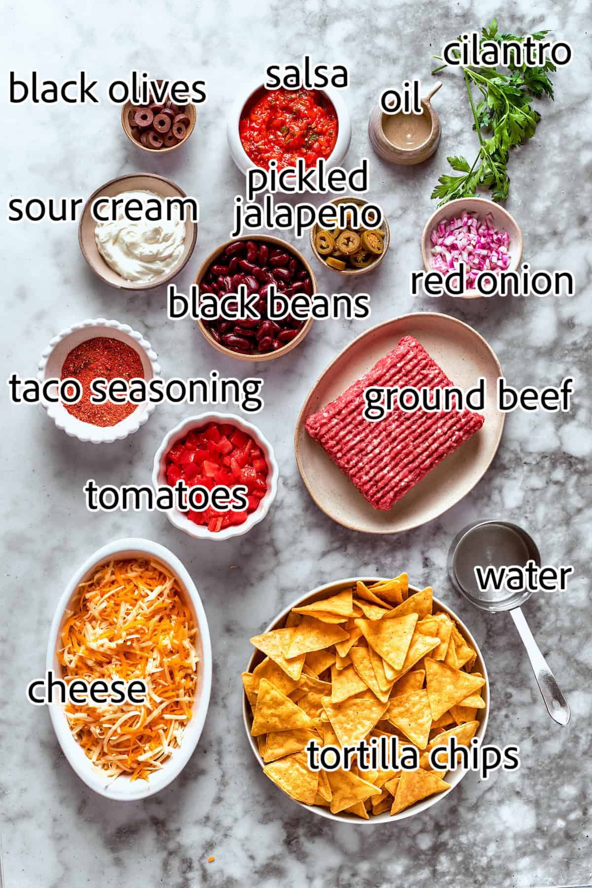 This Macho Nachos recipe features layers of crispy tortilla chips, melty cheese, and seasoned beef. Perfect for any casual gathering! ingredients needed to make macho nachos