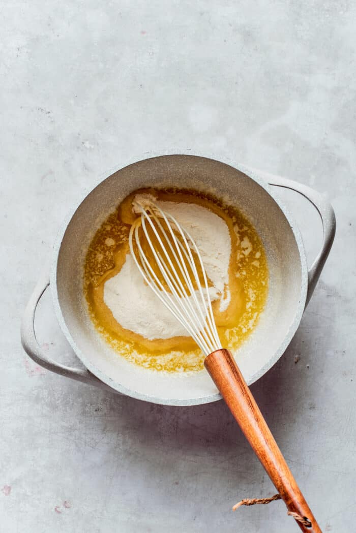 Rømmegrøt is a warmed Norwegian porridge similar to rich pudding, served with a drizzle of melted butter and a good sprinkling of cinnamon! Flour is whisked into melted butter.