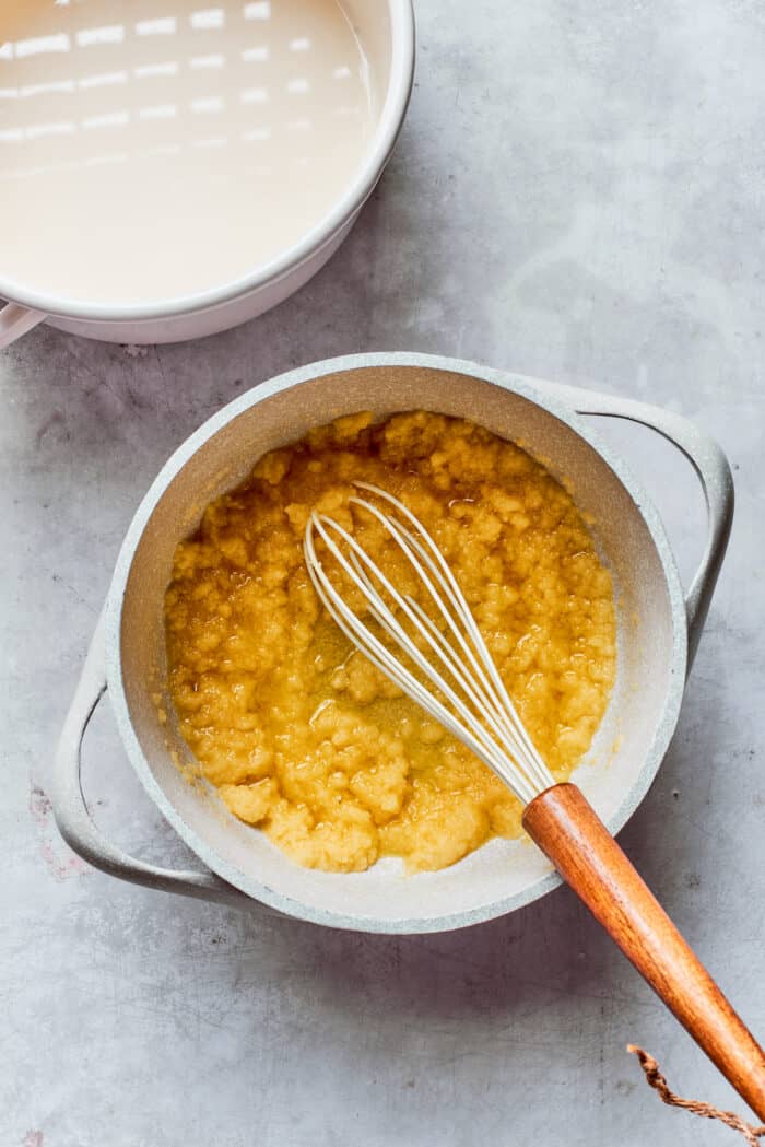 Rømmegrøt is a warmed Norwegian porridge similar to rich pudding, served with a drizzle of melted butter and a good sprinkling of cinnamon! Flour, butter, and sugar are whisked in a pot.