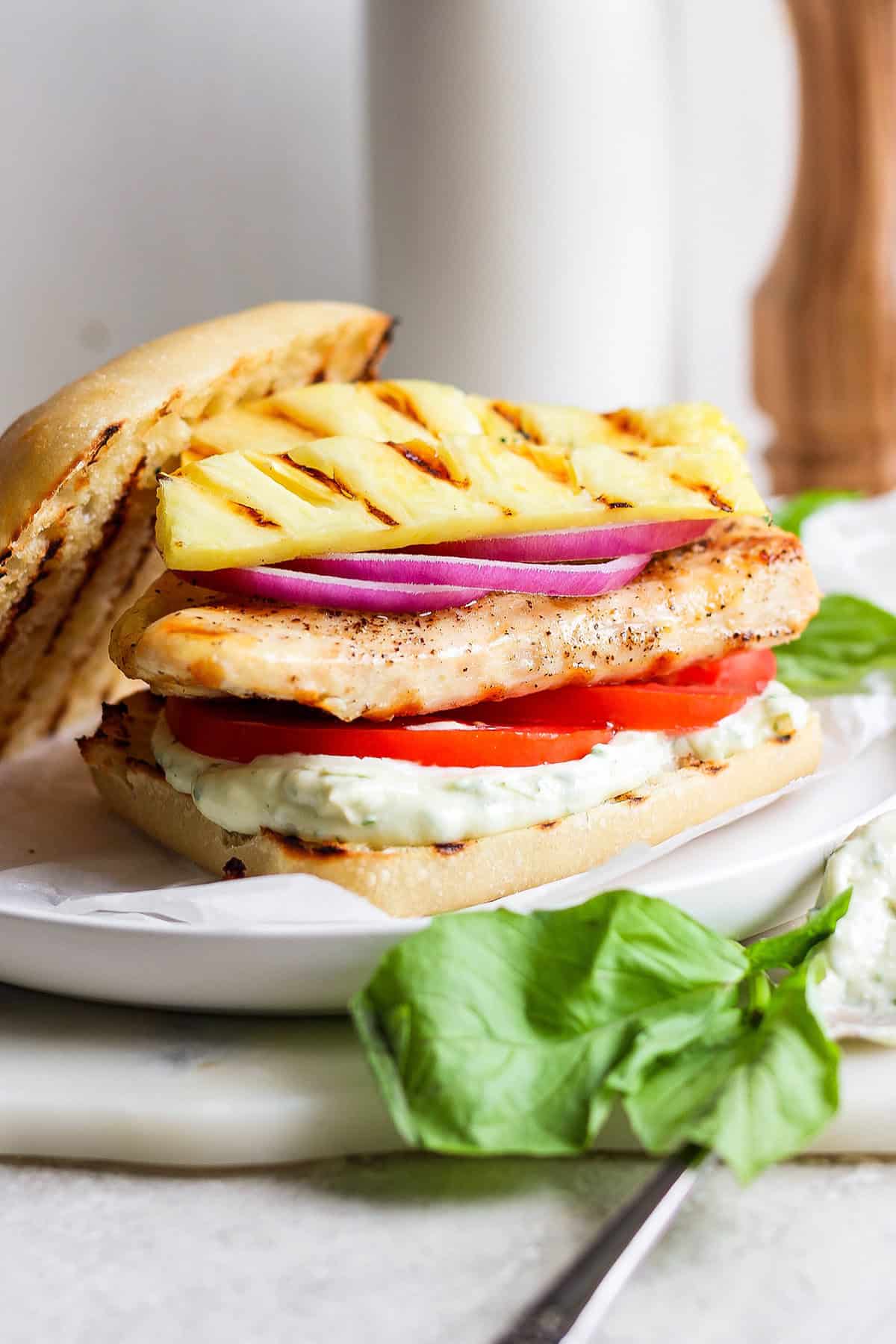 This easy Grilled Chicken Sandwich recipe stars tender, juicy chicken, sweet grilled pineapple, and a creamy homemade basil sauce.