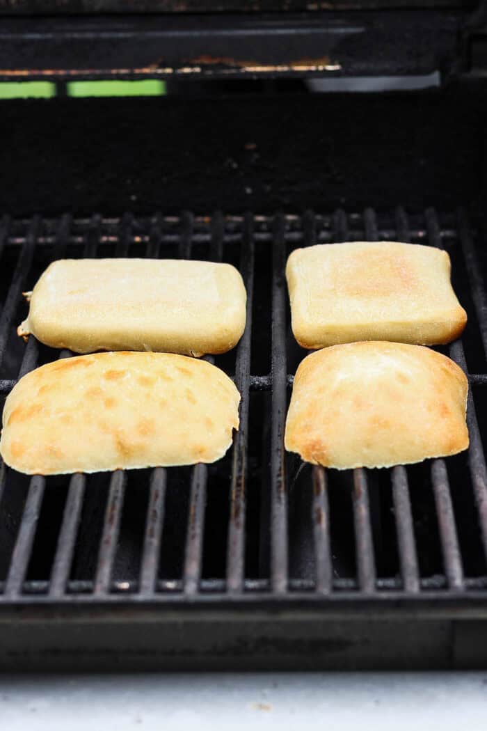This easy Grilled Chicken Sandwich recipe stars tender, juicy chicken, sweet grilled pineapple, and a creamy homemade basil sauce. Ciabatta rolls toast on the grill.