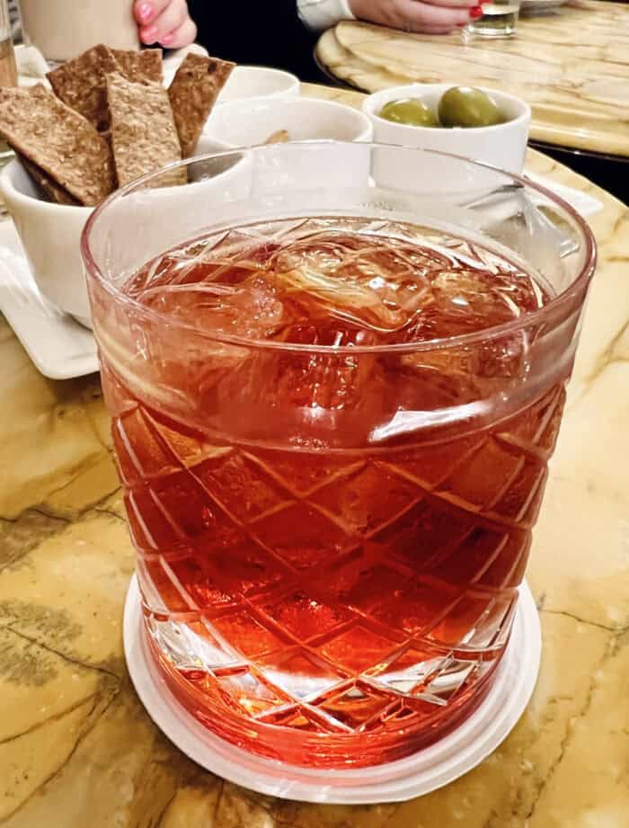 A glass of Negroni cocktail drink at a cafe in Florence, Italy