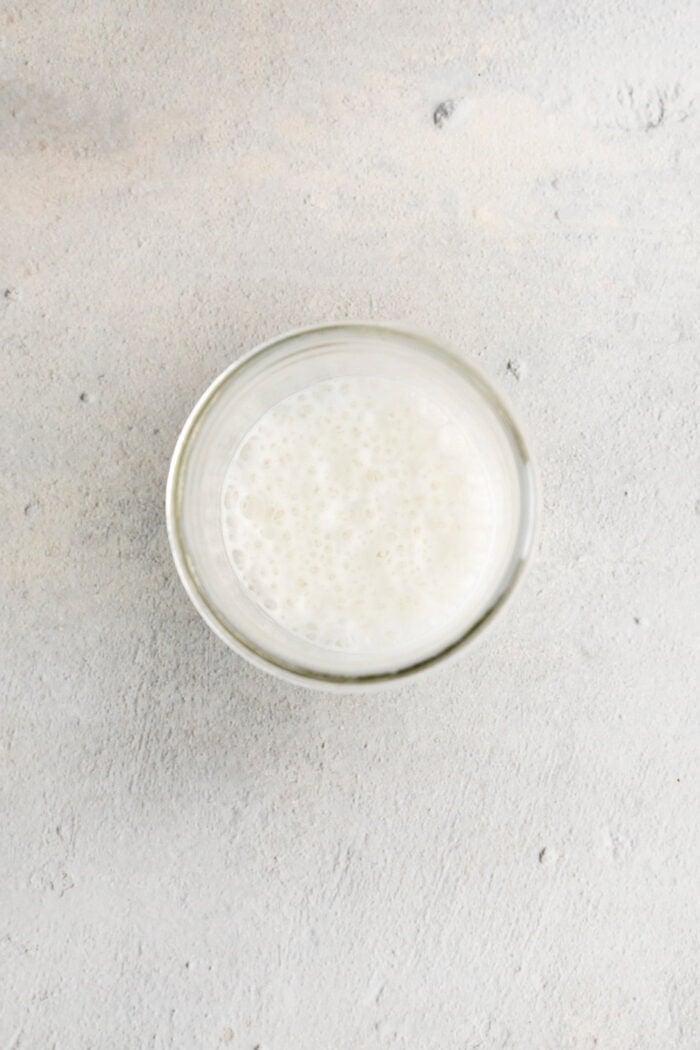 This Pumpkin Spice Latte has a base of pumpkin sauce sweetened with maple sugar that's mixed with strong espresso and topped with frothy milk. Frothed milk in a jar.