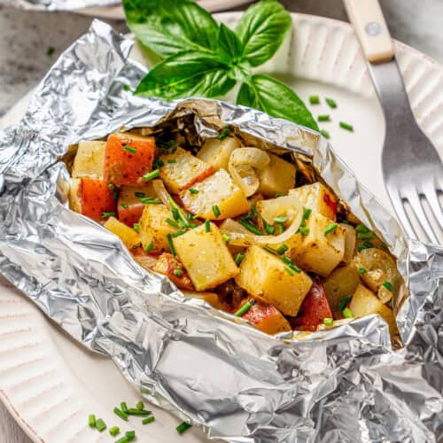 an opened foil packet of grilled potatoes