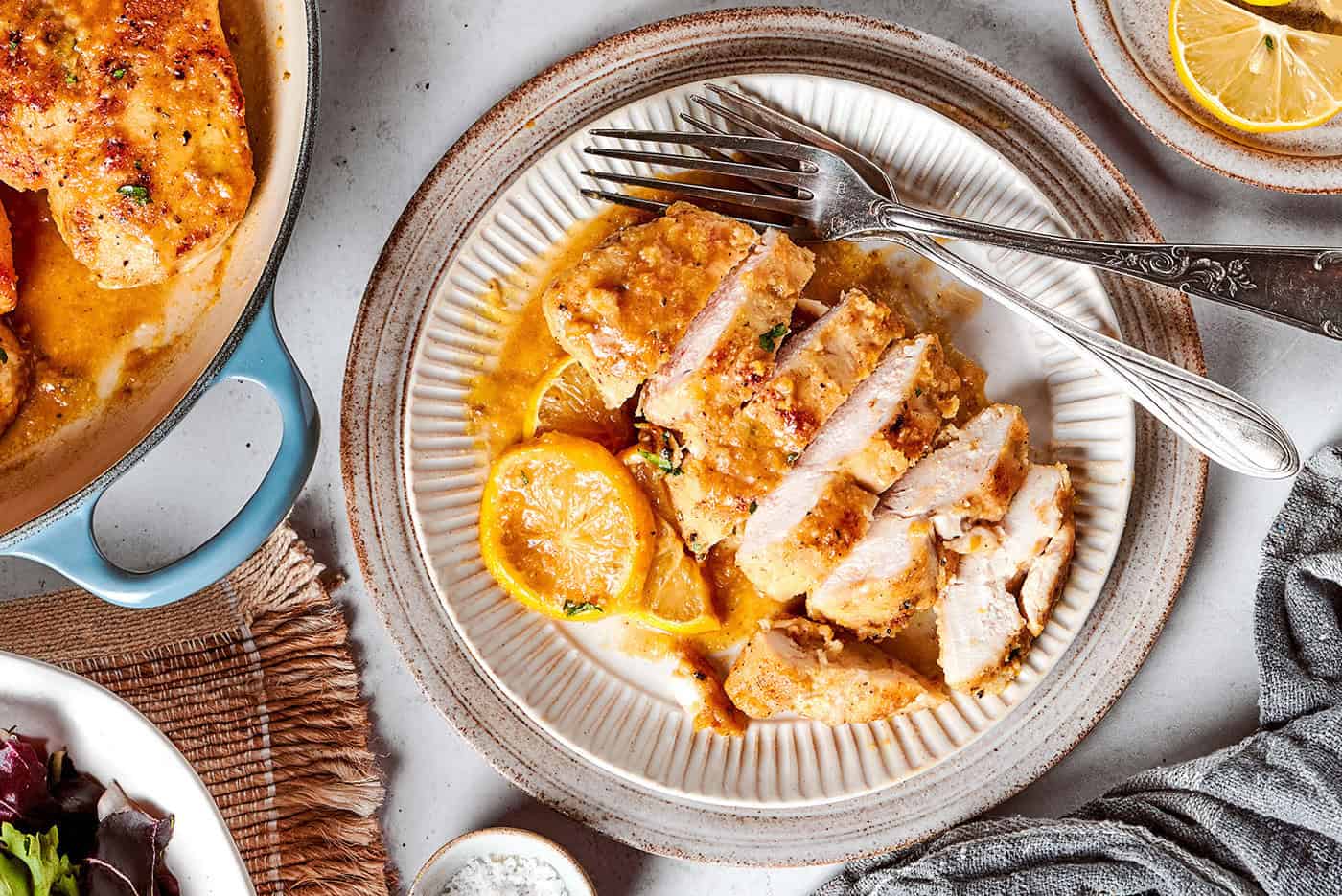 This juicy and tender Lemon Pepper Chicken recipe punches up ordinary chicken with a burst of bright, fresh lemon and a simple sauce. a sliced chicken breast with lemon and pepper, on a plate