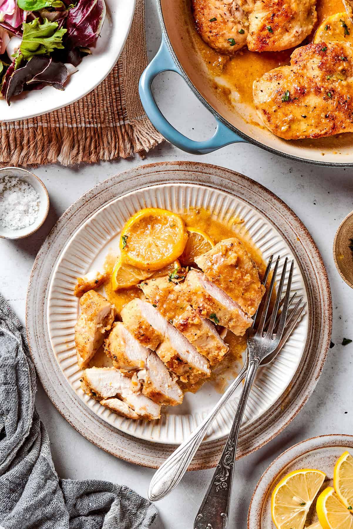 This juicy and tender Lemon Pepper Chicken recipe punches up ordinary chicken with a burst of bright, fresh lemon and a simple sauce. a sliced chicken breast with lemon and pepper, on a plate