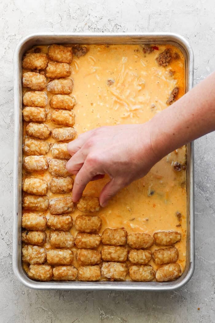 This garlicky tater tot breakfast casserole recipe with red peppers, onions, and sausage is an effortless morning bite. Adding the layer of frozen tater tots on top.