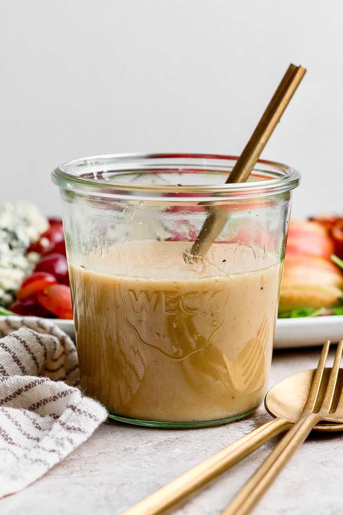 Creamy maple Dijon dressing in a glass jar. 