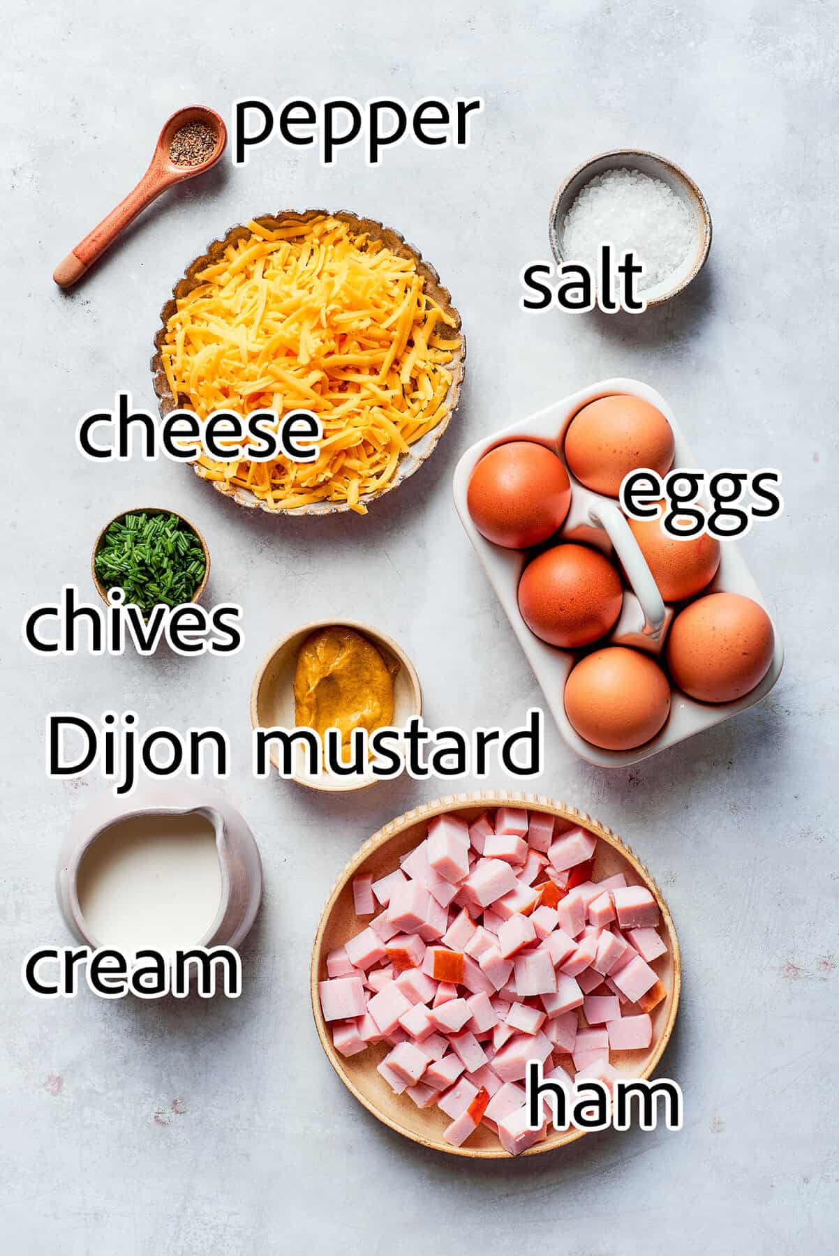 This cheesy crustless quiche recipe with ham, tangy Dijon, and chives is an easy baked dish for the holidays. ingredients needed to make a crustless quiche recipe