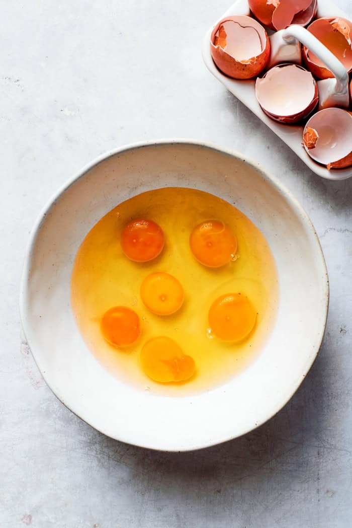 eggs cracked into a mixing bowl