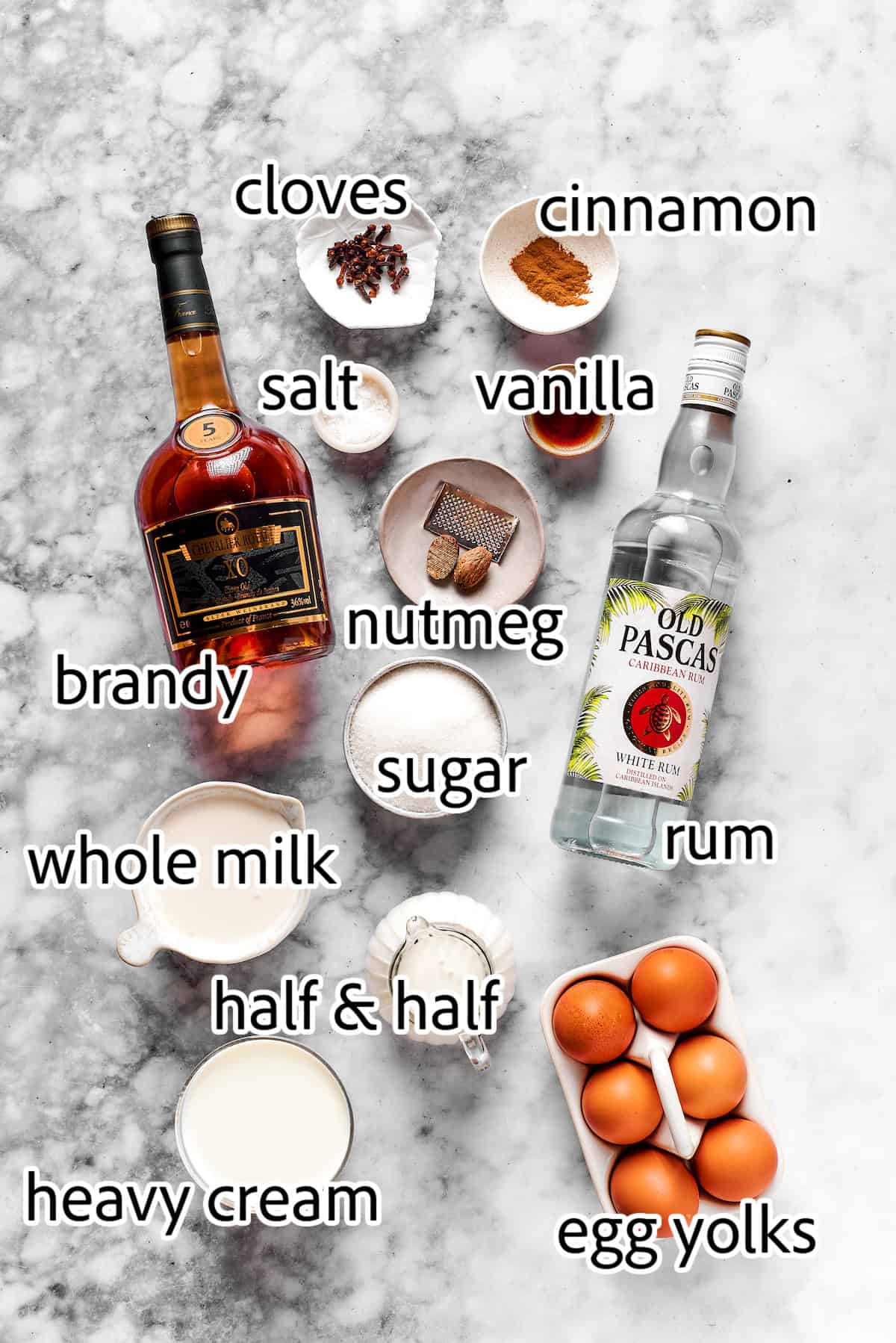 This spiced homemade eggnog recipe with brandy, smokey rum, and fluffy whipped cream is the perfect cocktail for holiday gatherings. ingredients to make homemade eggnog