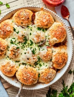 overhead photo of pizza bites in a white baking dish