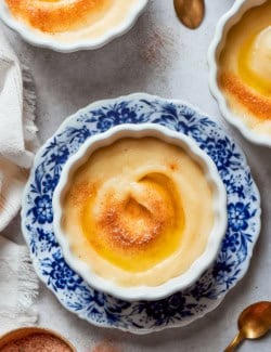 Norwegian rommegrot in a white bowl, with cinnamon-sugar and melted butter