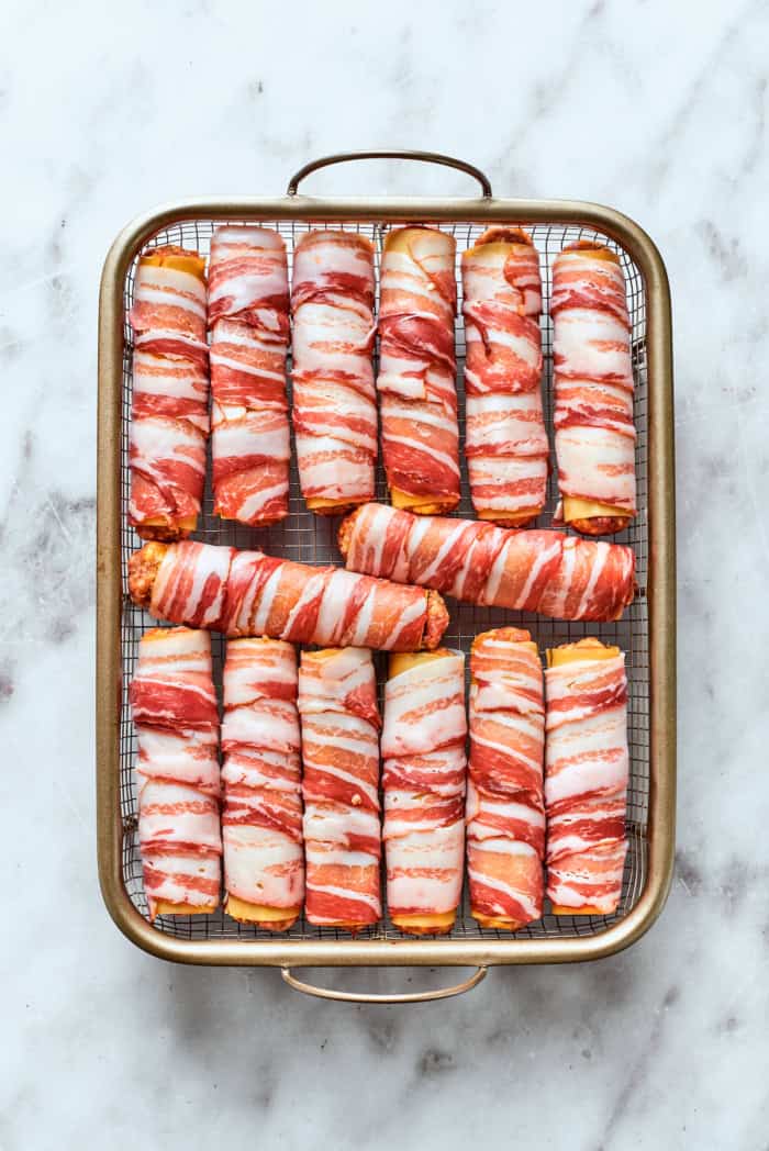 This baked shotgun shells recipe is a simpler version you can make in the oven — no smoker required! Smoky, savory, spicy and irresistible! Uncooked shotgun shells in wire basket