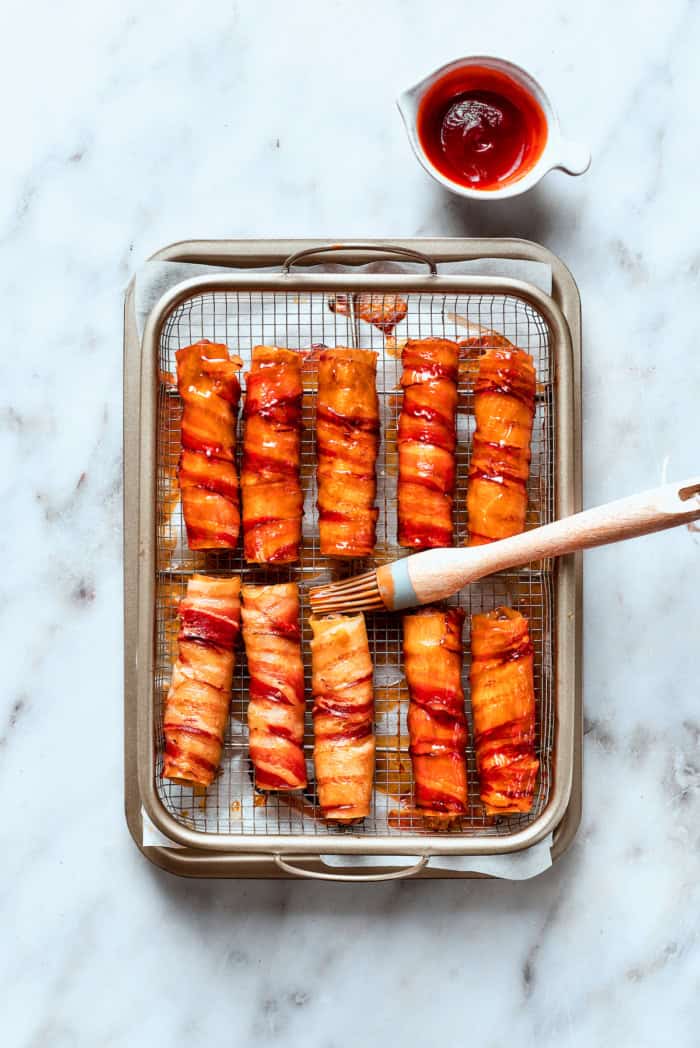This baked shotgun shells recipe is a simpler version you can make in the oven — no smoker required! Smoky, savory, spicy and irresistible! Brushing barbecue sauce onto oven-baked shotgun shells