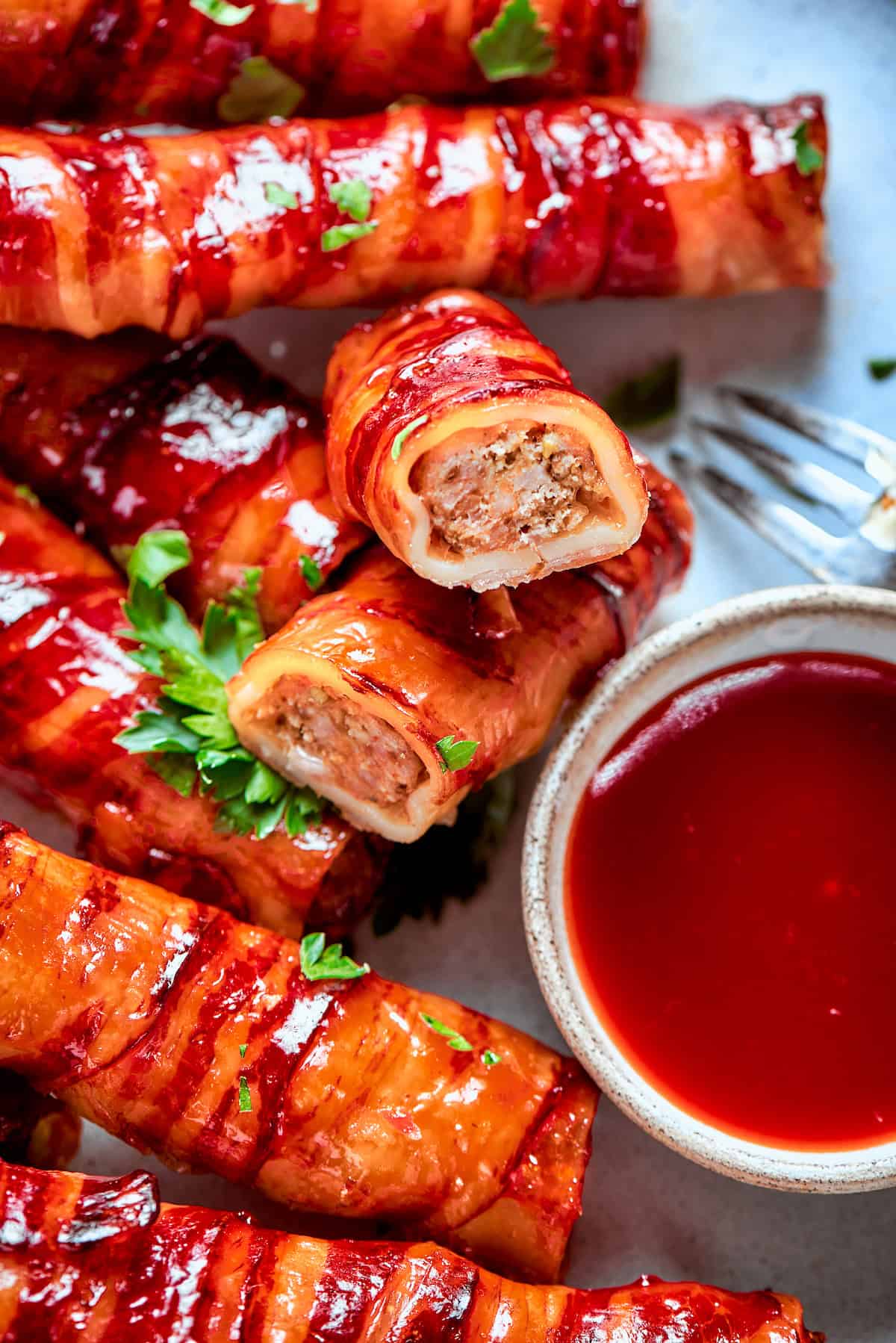 This baked shotgun shells recipe is a simpler version you can make in the oven — no smoker required! Smoky, savory, spicy and irresistible! Shotgun shell cut in half to show meaty filling