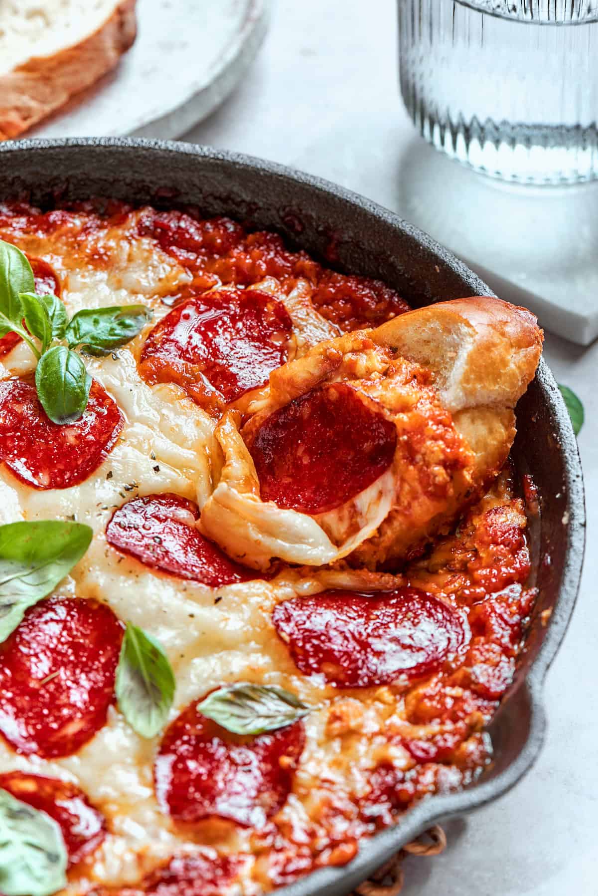 cheesy pizza dip in a cast iron pan