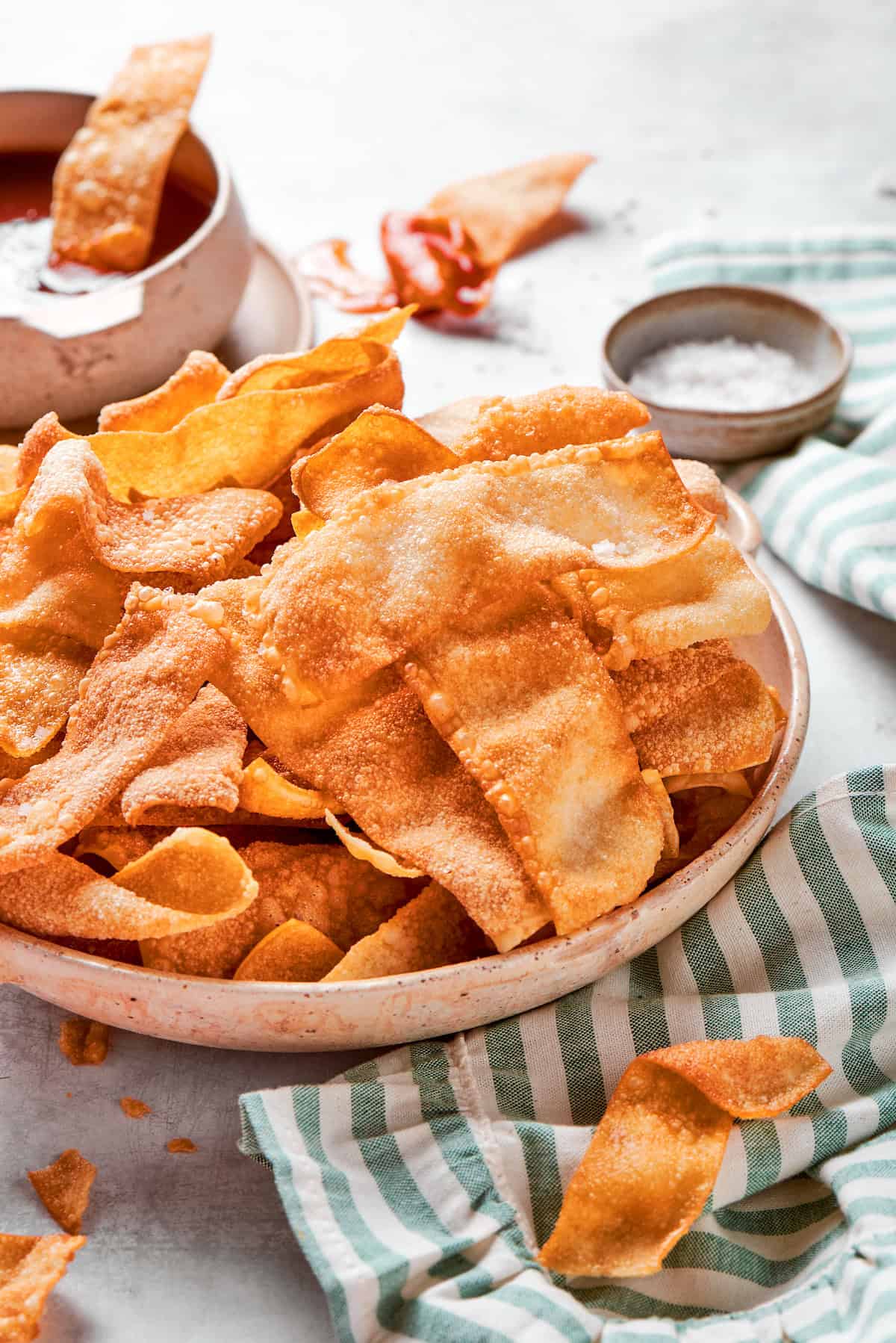 These easy homemade wonton chips have the most fantastic crunch and a salty flavor that makes them pair with just about anything! Bowl of crispy fried wonton chips