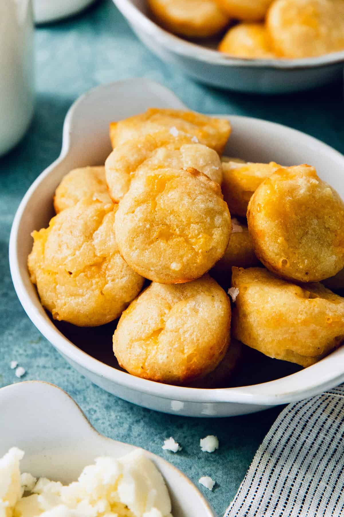 This Colombian Pandebono recipe is fantastically cheesy, surprisingly easy, and irresistibly tender and fluffy. So delicious! Bowl of Colombian pandebono