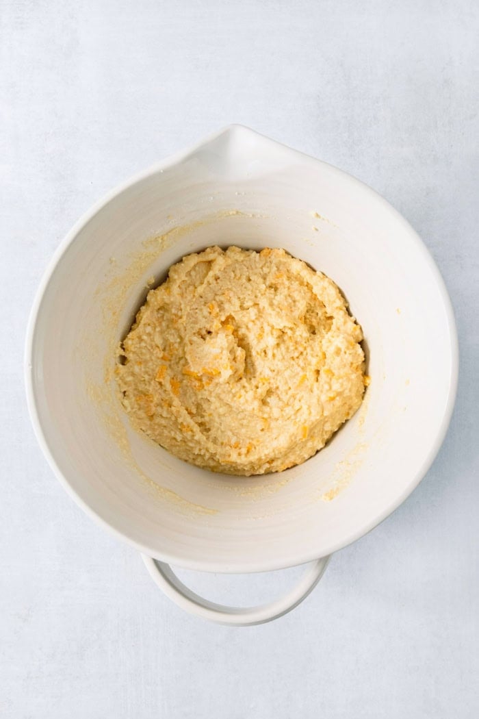 This Colombian Pandebono recipe is fantastically cheesy, surprisingly easy, and irresistibly tender and fluffy. So delicious! Overhead view of pandebono batter in bowl