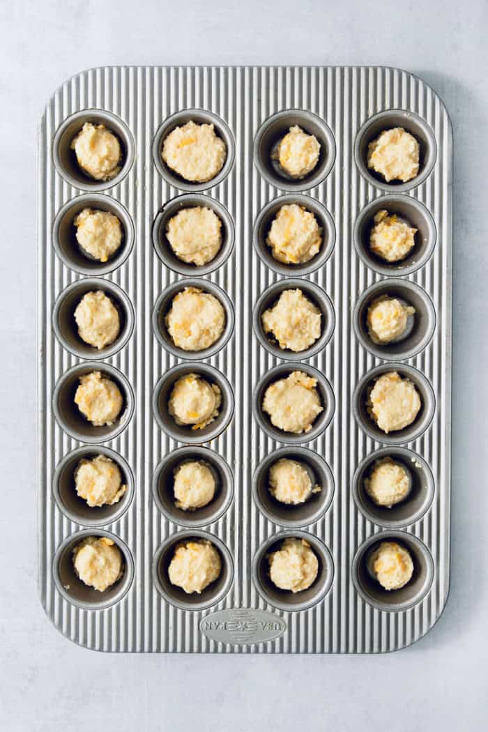 This Colombian Pandebono recipe is fantastically cheesy, surprisingly easy, and irresistibly tender and fluffy. So delicious! Overhead view of pandebono batter in pan