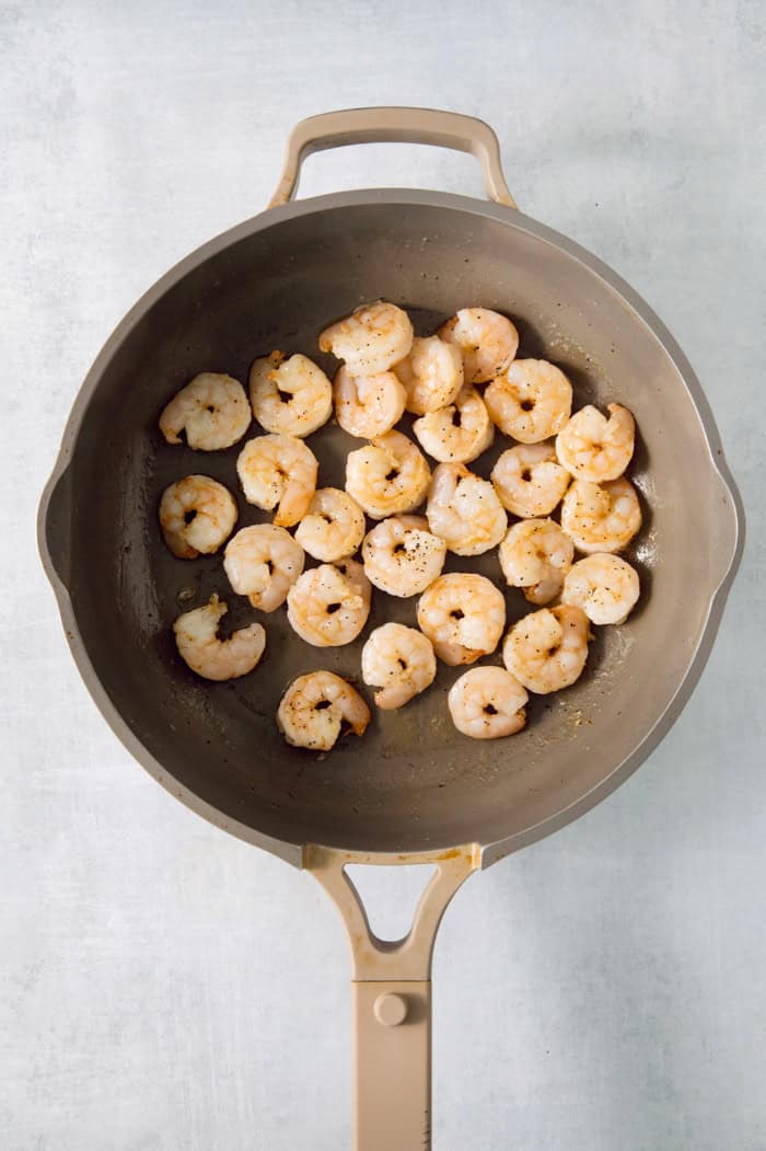 This easy Shrimp Curry recipe combines elements of Thai and Indian curries for a uniquely delicious weeknight meal. So quick and easy! Searing shrimp in pan