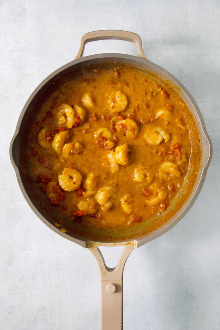 This easy Shrimp Curry recipe combines elements of Thai and Indian curries for a uniquely delicious weeknight meal. So quick and easy! Overhead view of shrimp curry in pan