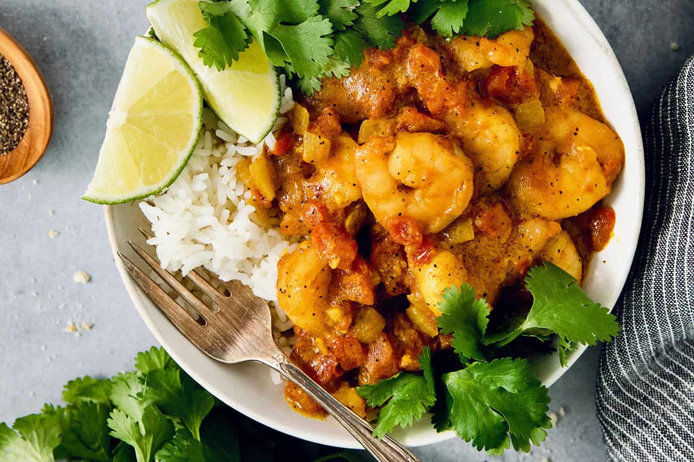 This easy Shrimp Curry recipe combines elements of Thai and Indian curries for a uniquely delicious weeknight meal. So quick and easy! Shrimp curry in bowl with rice