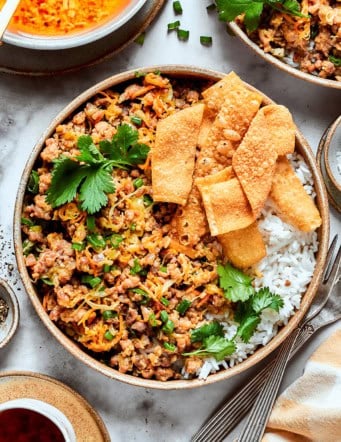 egg roll in a bowl, served in pottery bowls over white rice