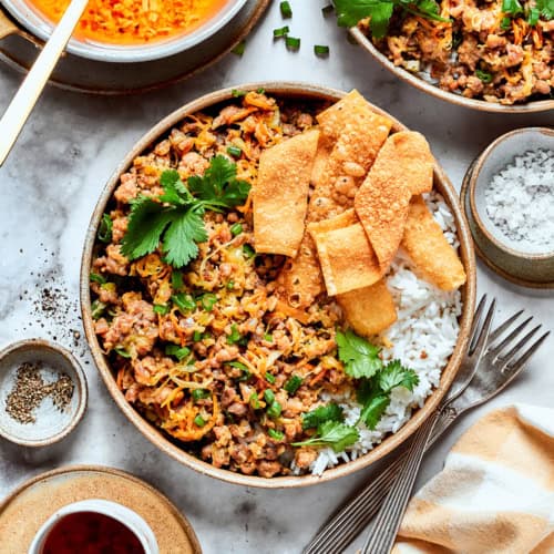 egg roll in a bowl, served in pottery bowls over white rice