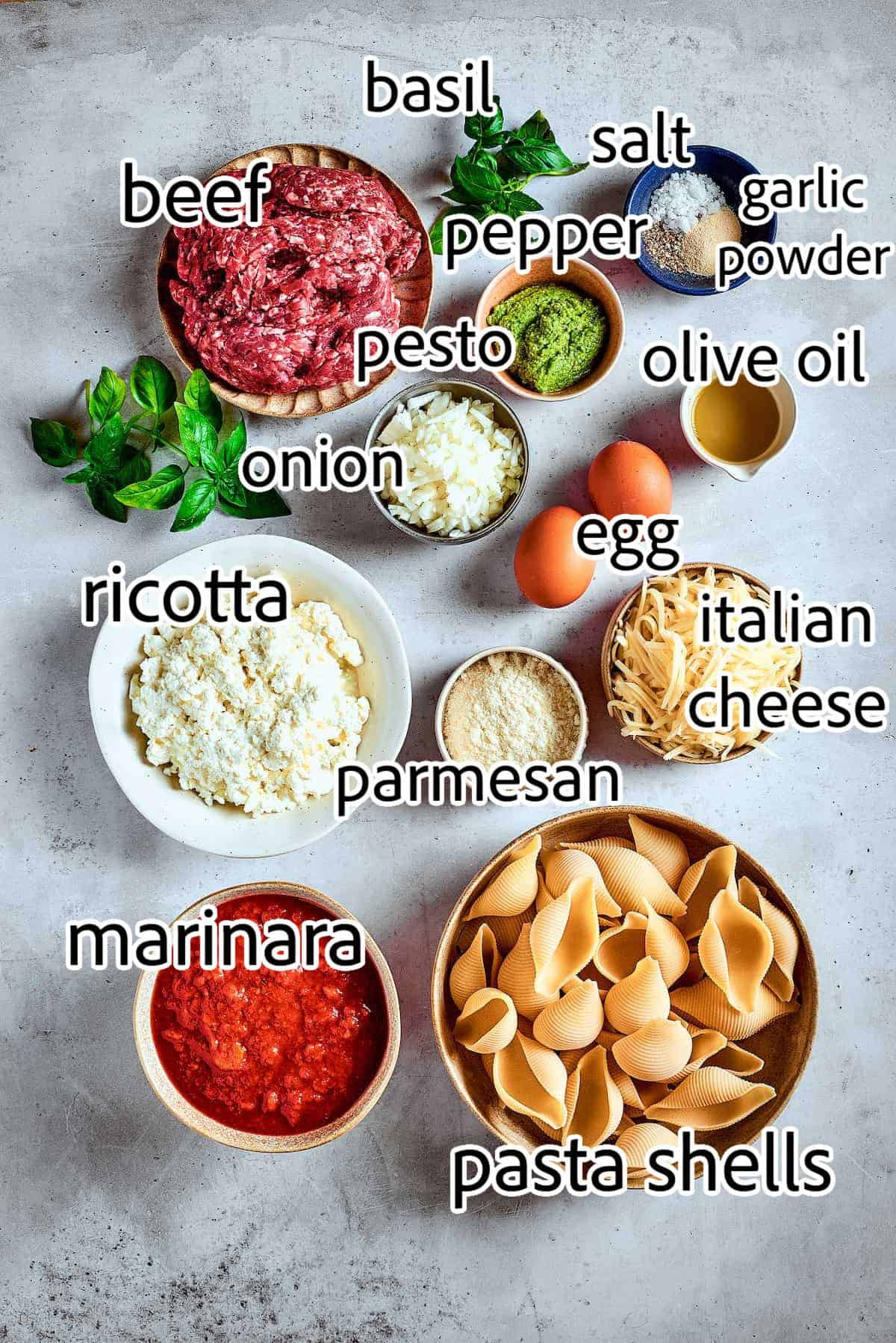 Cozy Stuffed Shells with Meat are packed with plenty of ground beef and a creamy, pesto-spiked filling to make a hearty meal. ingredients needed for stuffed shells with meat